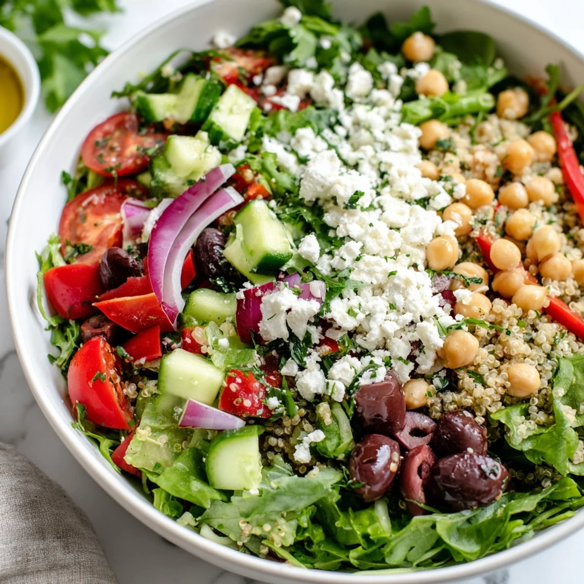 A hearty Mediterranean Supper Salad served with lemon wedges, ideal for a quick, vegetarian dinner.