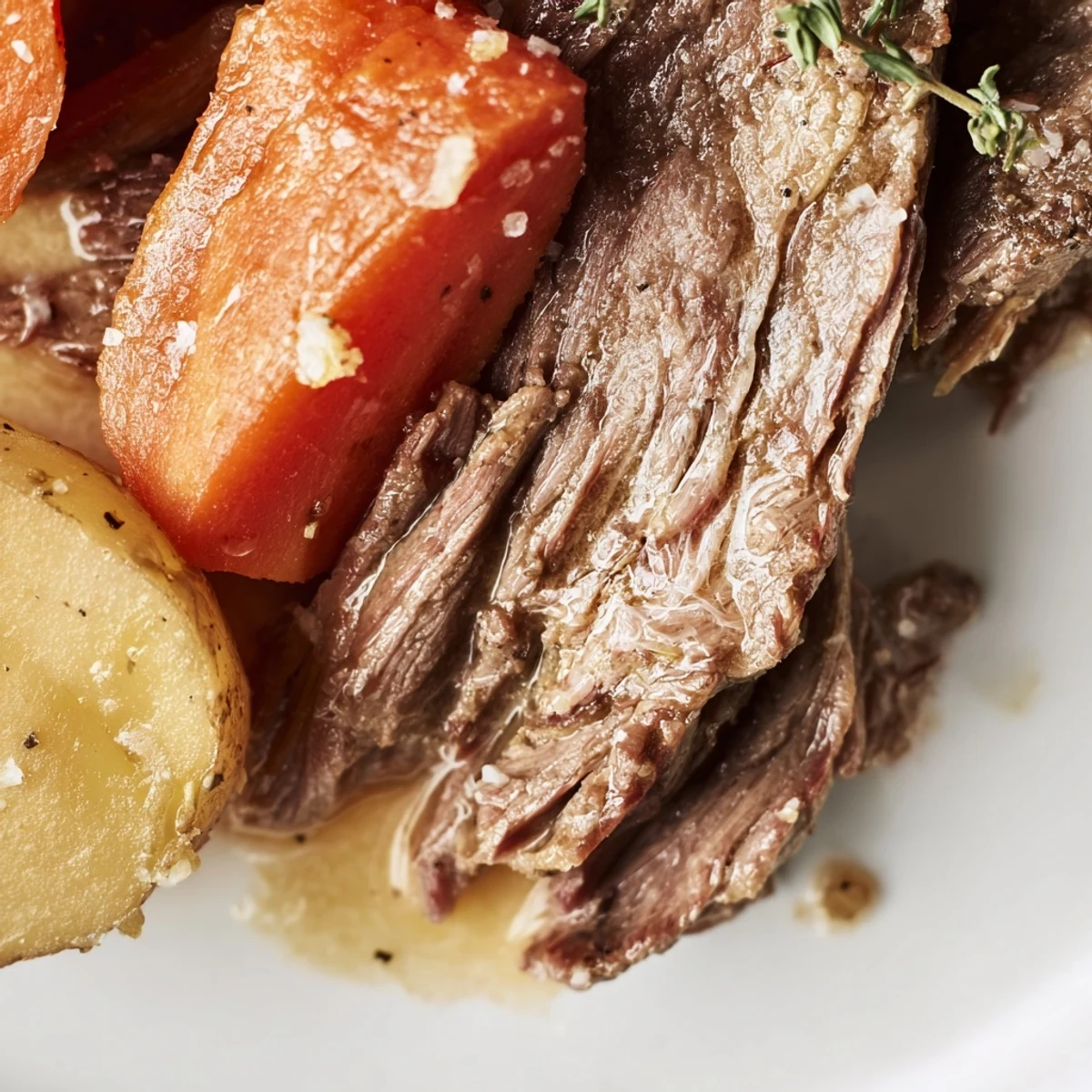 Golden brown Beef Supper Roast surrounded by tender potatoes and carrots in rich pan juices.