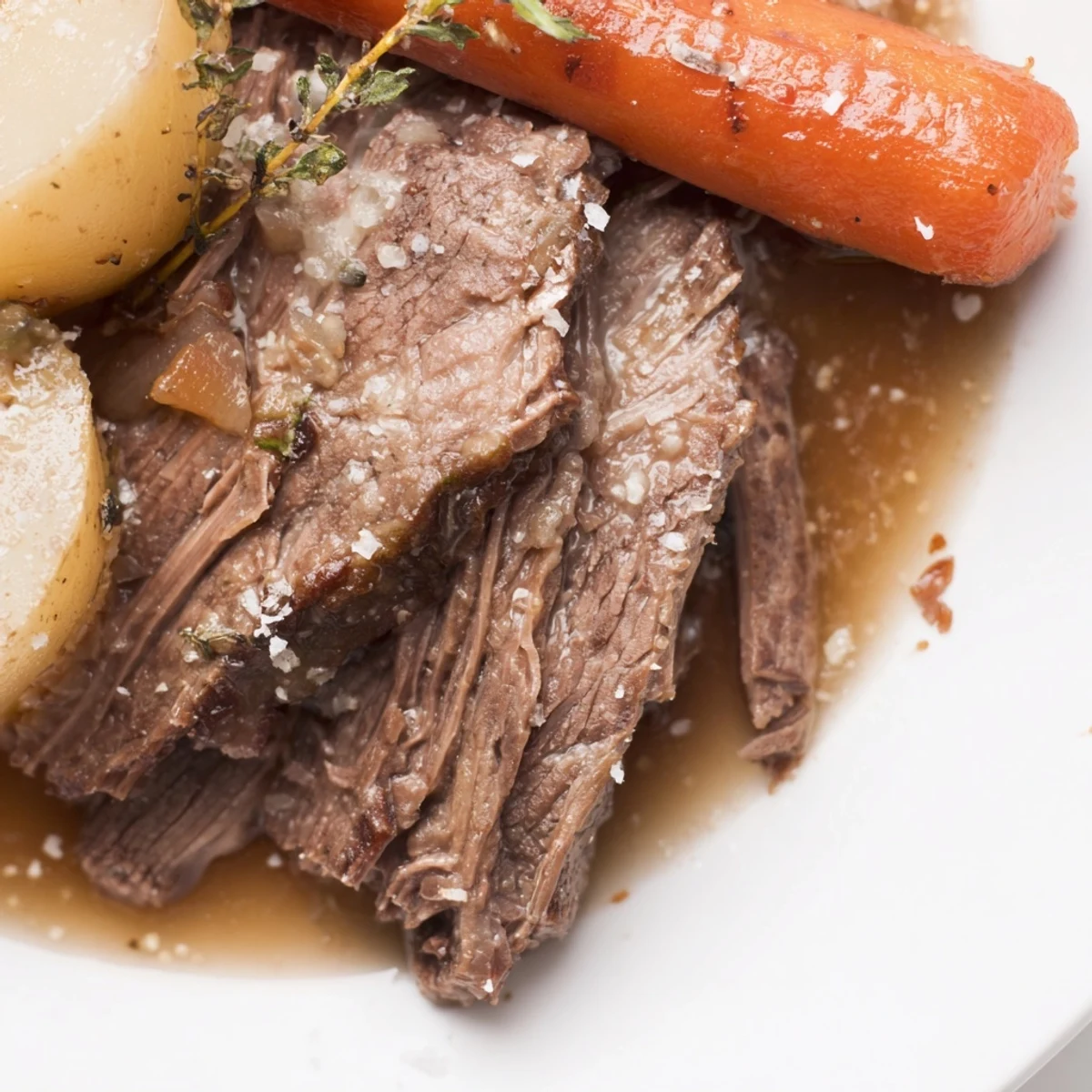 Freshly roasted Beef Supper Roast served in a Dutch oven with root vegetables and herbs.