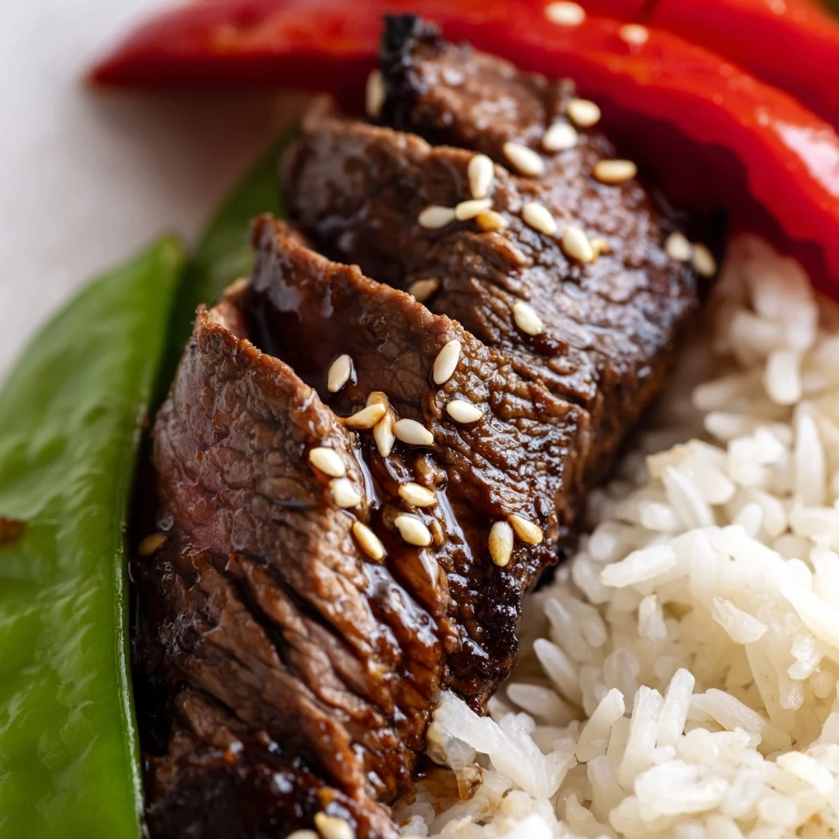 Tender beef strips and crisp vegetables over fluffy steamed rice in a Beef Lunch Bowl, garnished with sesame seeds.