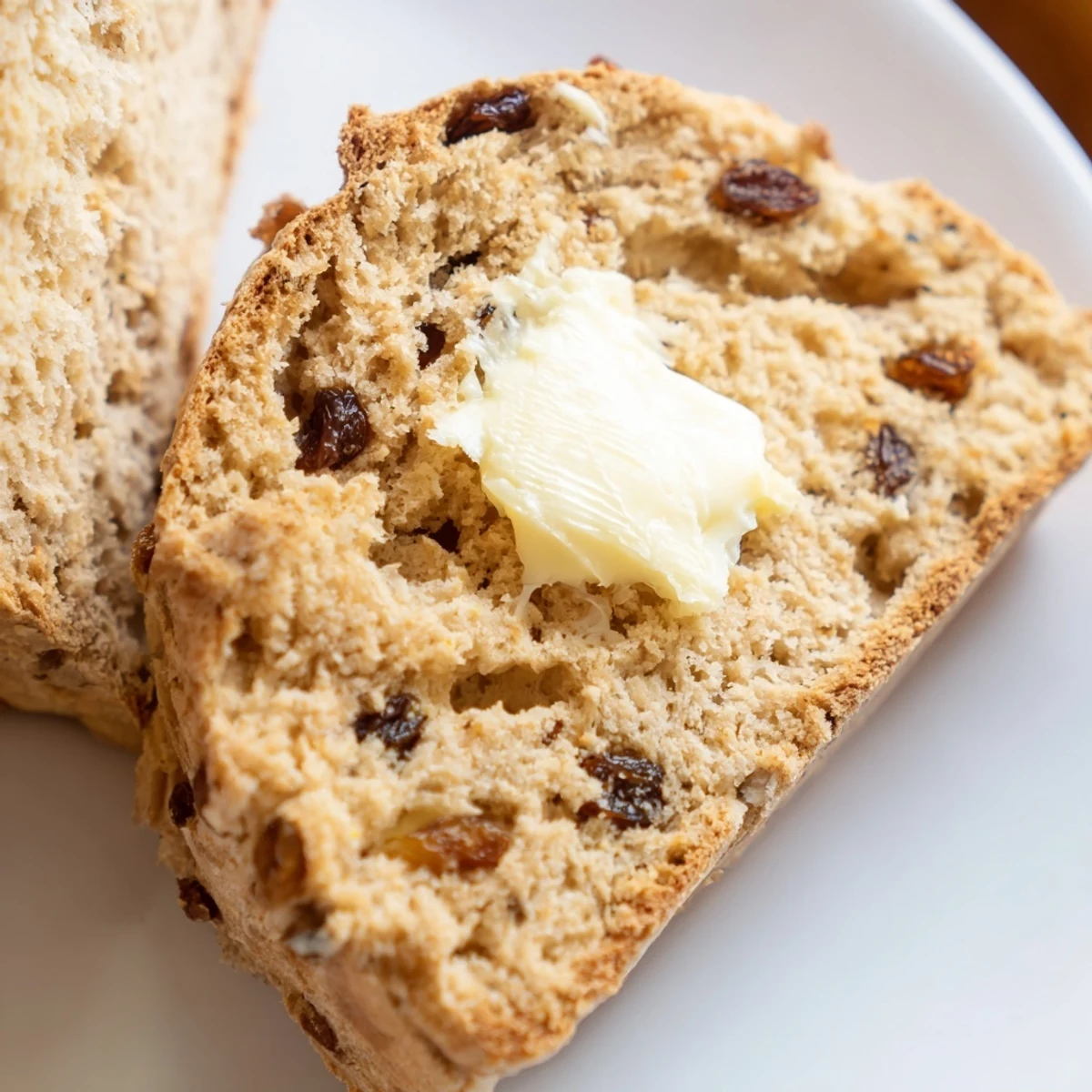 Golden-baked Irish Soda Bread with Raisins and Caraway Seeds, with a rustic, flour-dusted crust and tender, raisin-studded interior.  