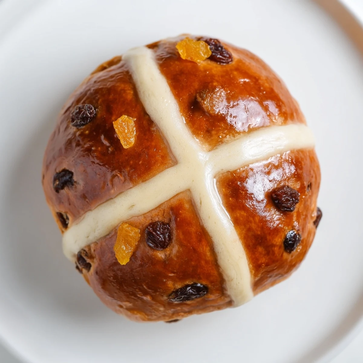 Moist and fluffy Easter Hot Cross Buns served warm on a ceramic platter, ready to be enjoyed with a cup of tea for a festive treat.