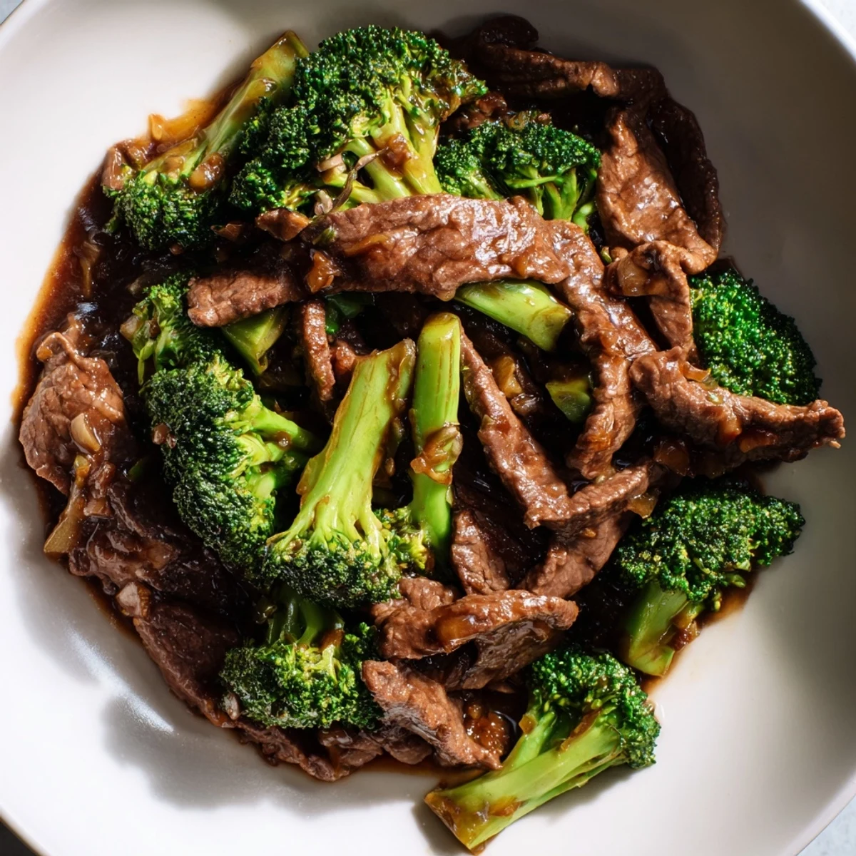 Beef and Broccoli with Soy Sauce plated family-style, garnished with sesame seeds and ready to enjoy on a busy weeknight.