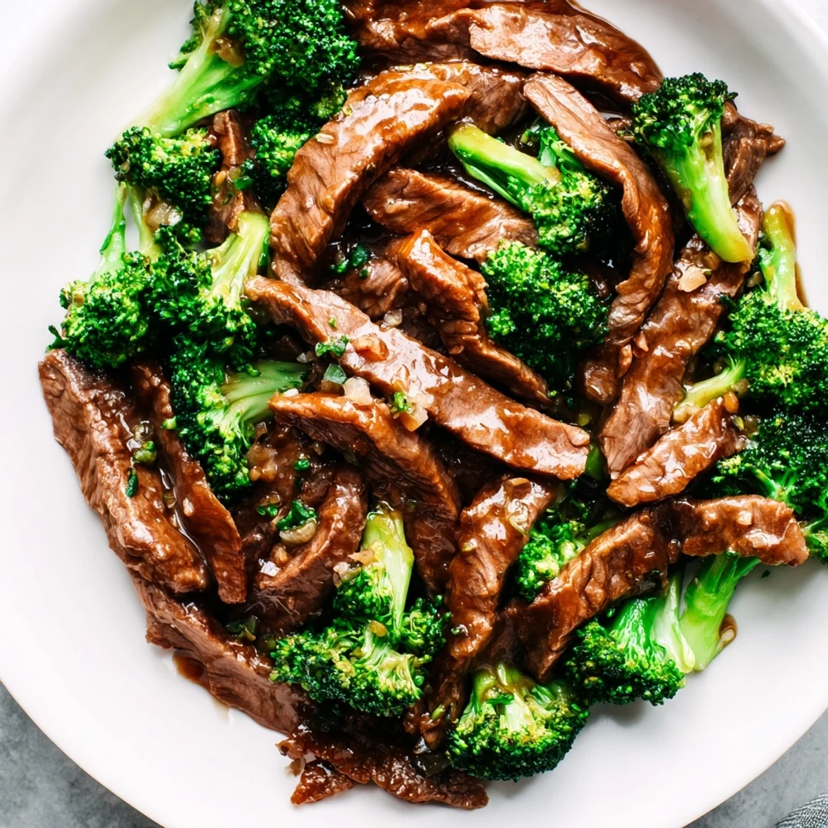 Sizzling Beef and Broccoli with Soy Sauce in a hot wok, glistening sauce coating tender beef and bright green crisp broccoli florets.