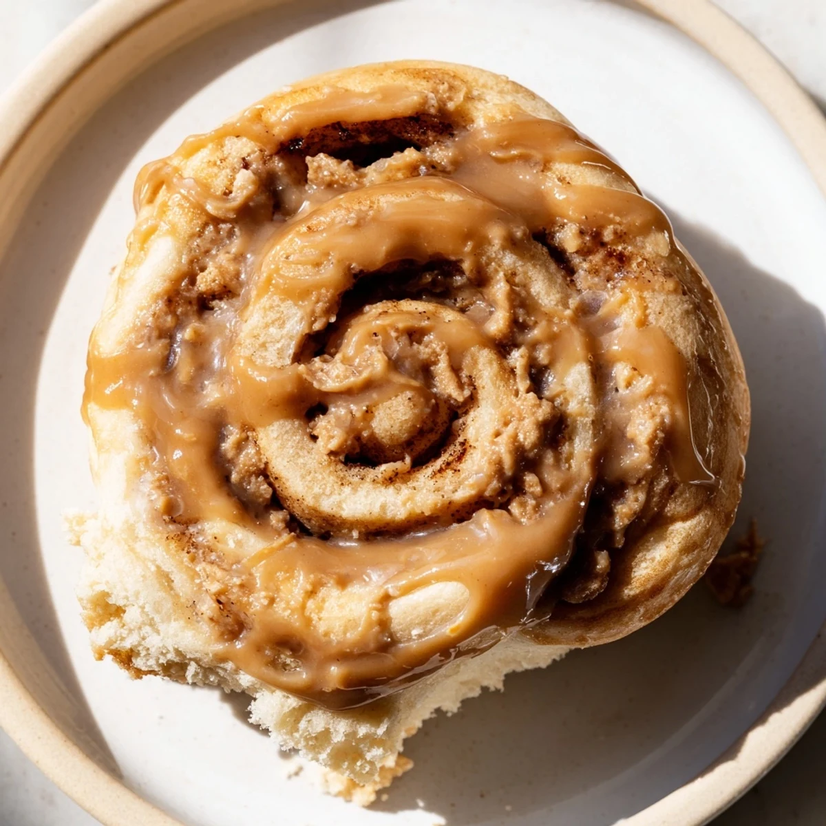 Fluffy Soft and Gooey Biscoff Cinnamon Rolls topped with luscious glaze, arranged in a baking dish.
