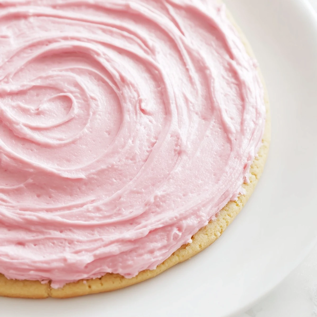 A close-up shows thick Giant Chilled Crumbl Sugar Cookies with soft centers and swirled pink frosting ready to serve.