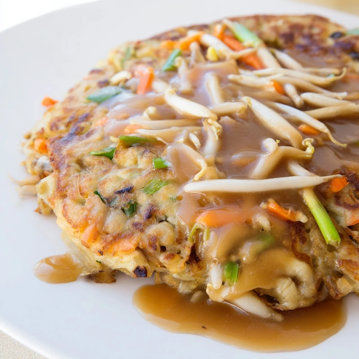 Golden crispy Egg Foo Young patties topped with rich savory brown gravy