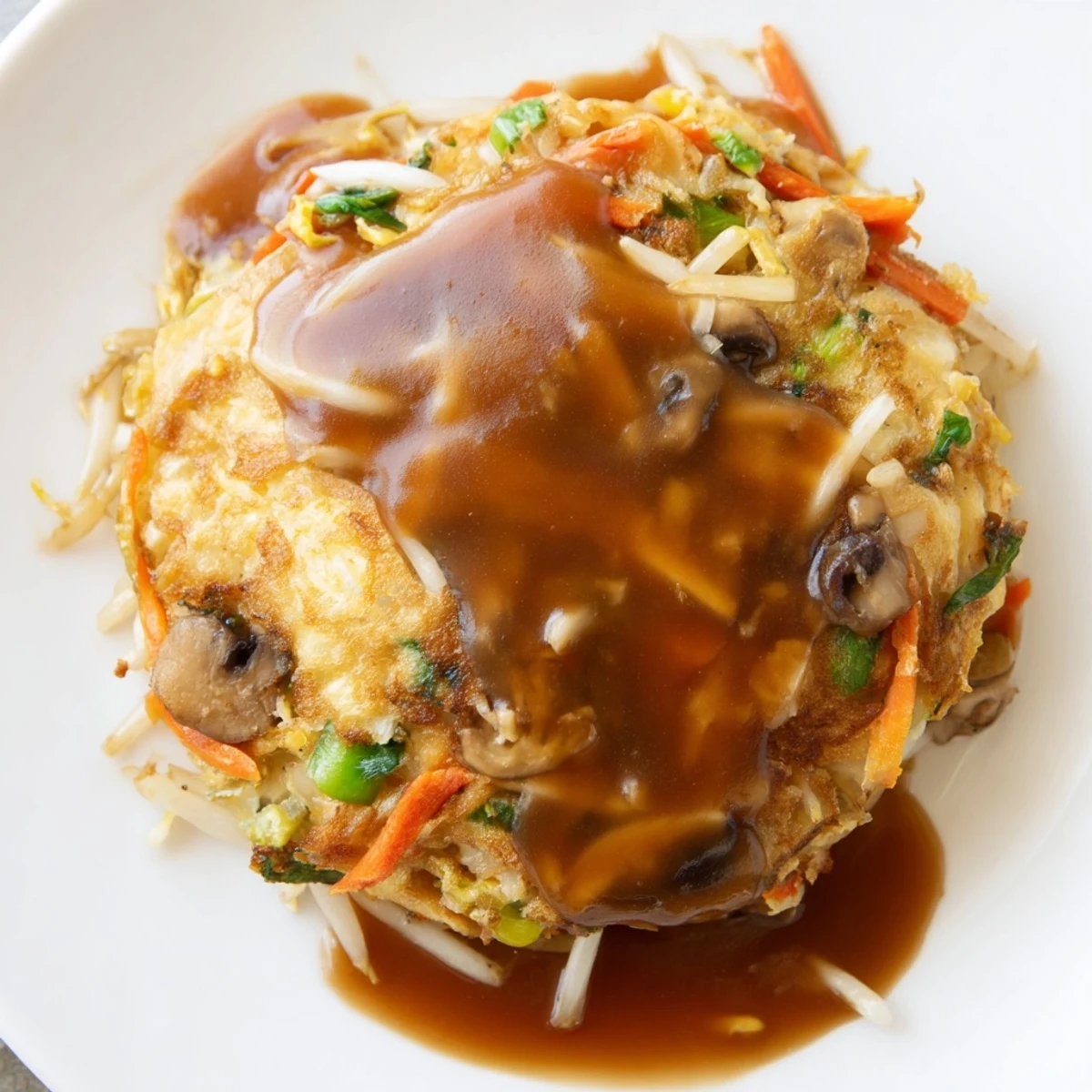 Fluffy Chinese omelet packed with colorful vegetables and served with thick sauce