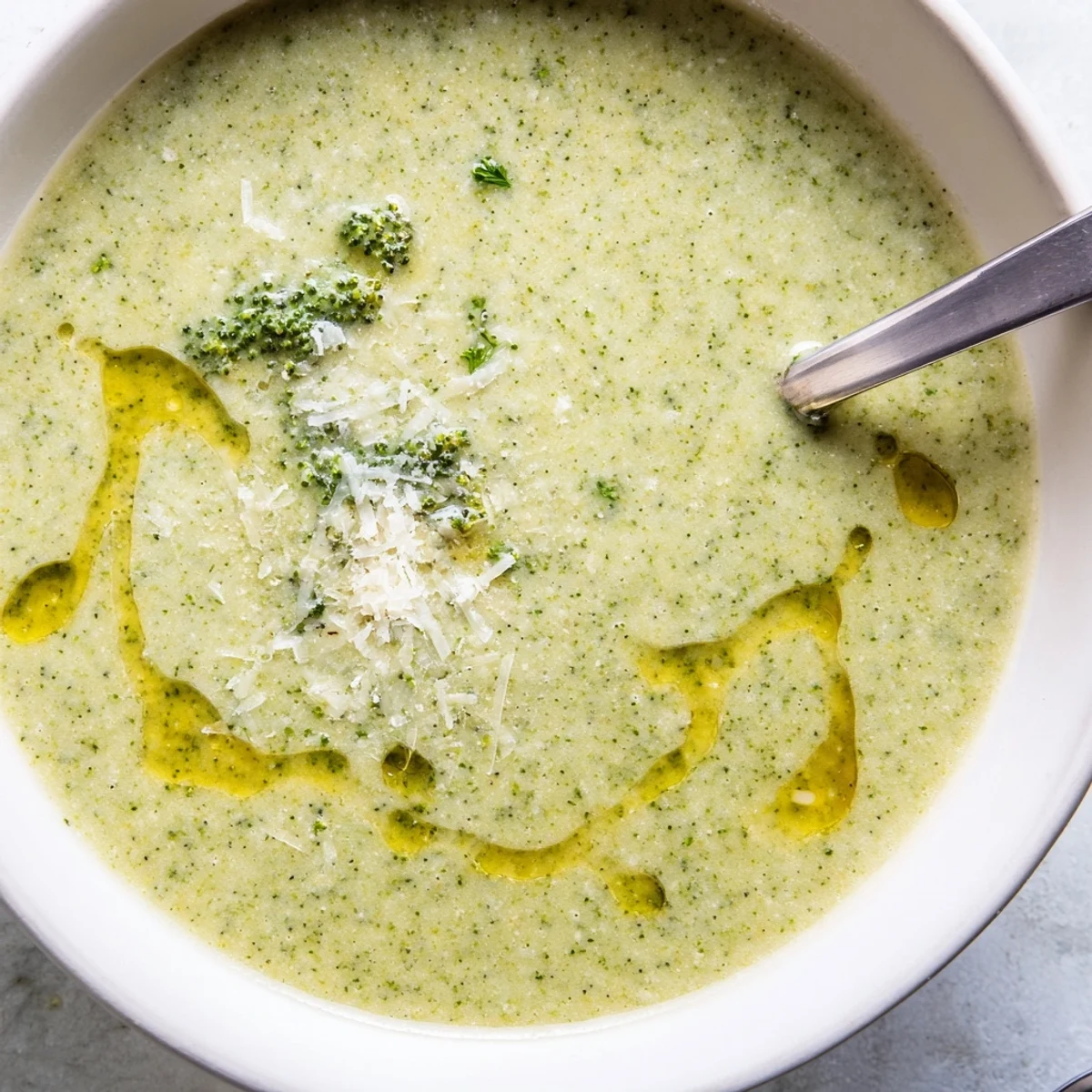 Velvety smooth homemade Italian broccoli soup drizzled with olive oil and served with crusty bread