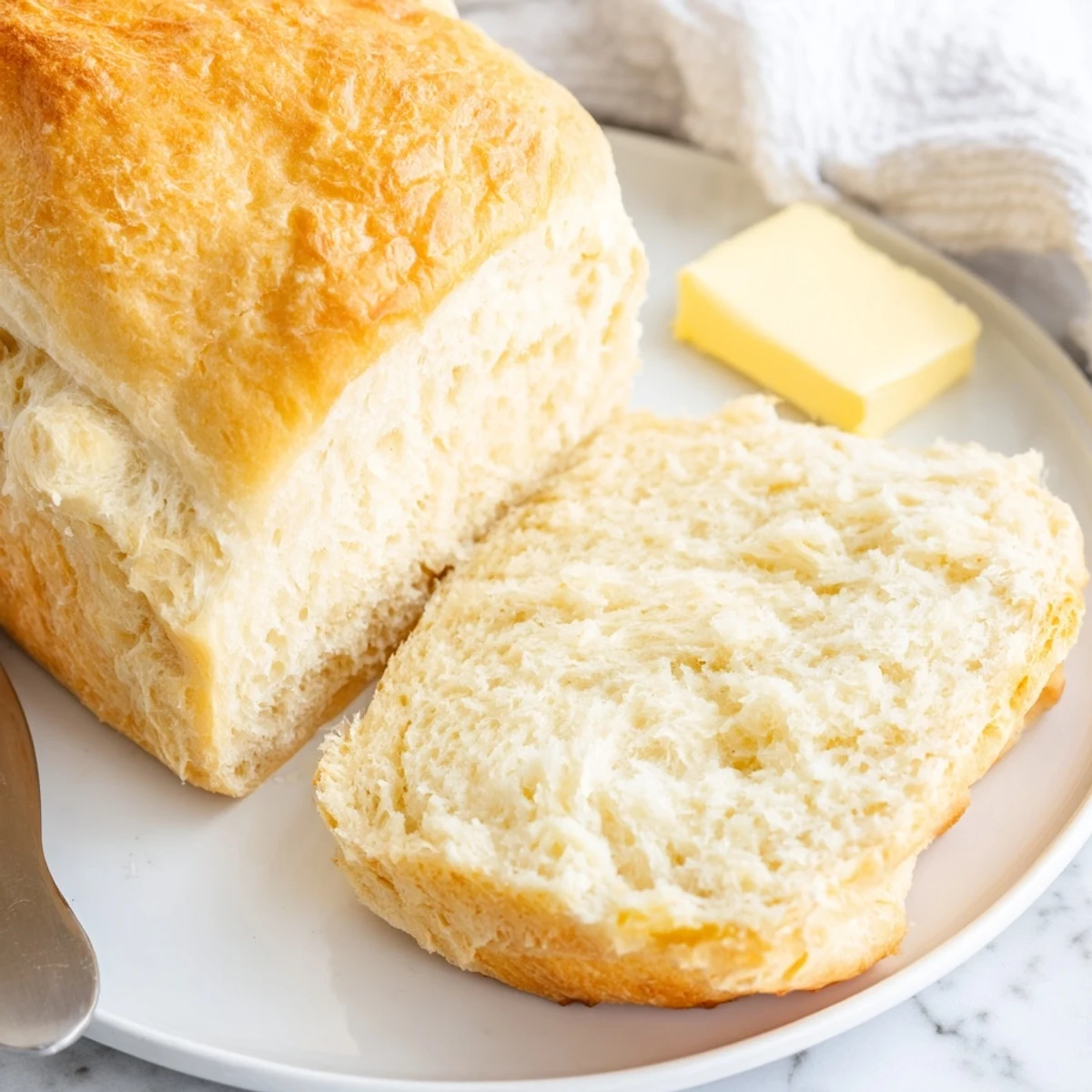 Golden brown stovetop bread with a fluffy interior, freshly cooked in a skillet