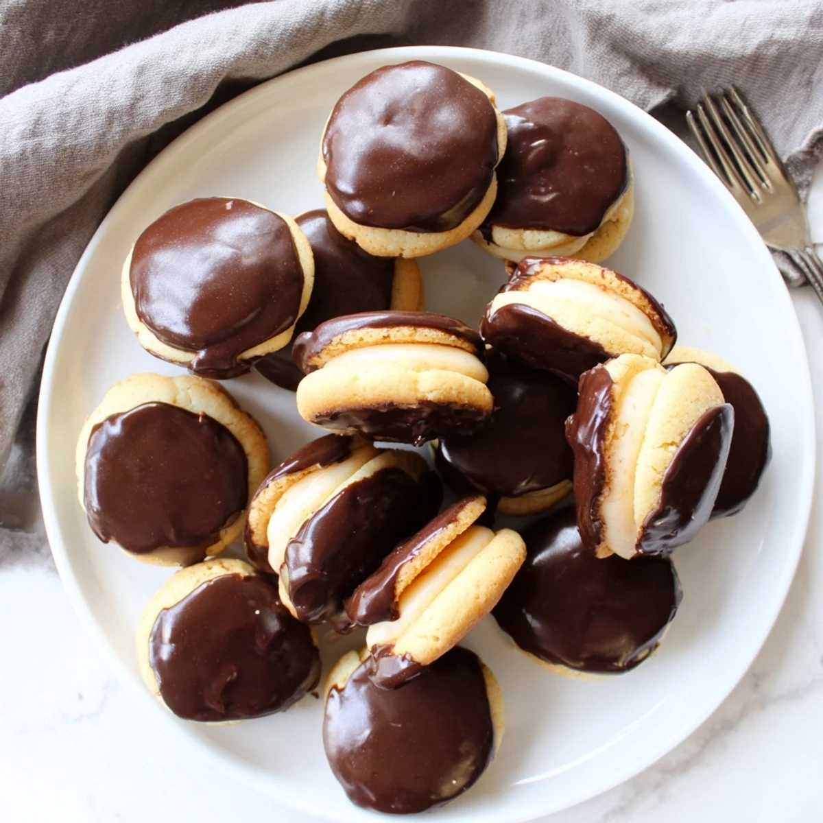 Golden vanilla Boston Cream Pie cookie bites featuring silky custard centers and a decadent chocolate coating