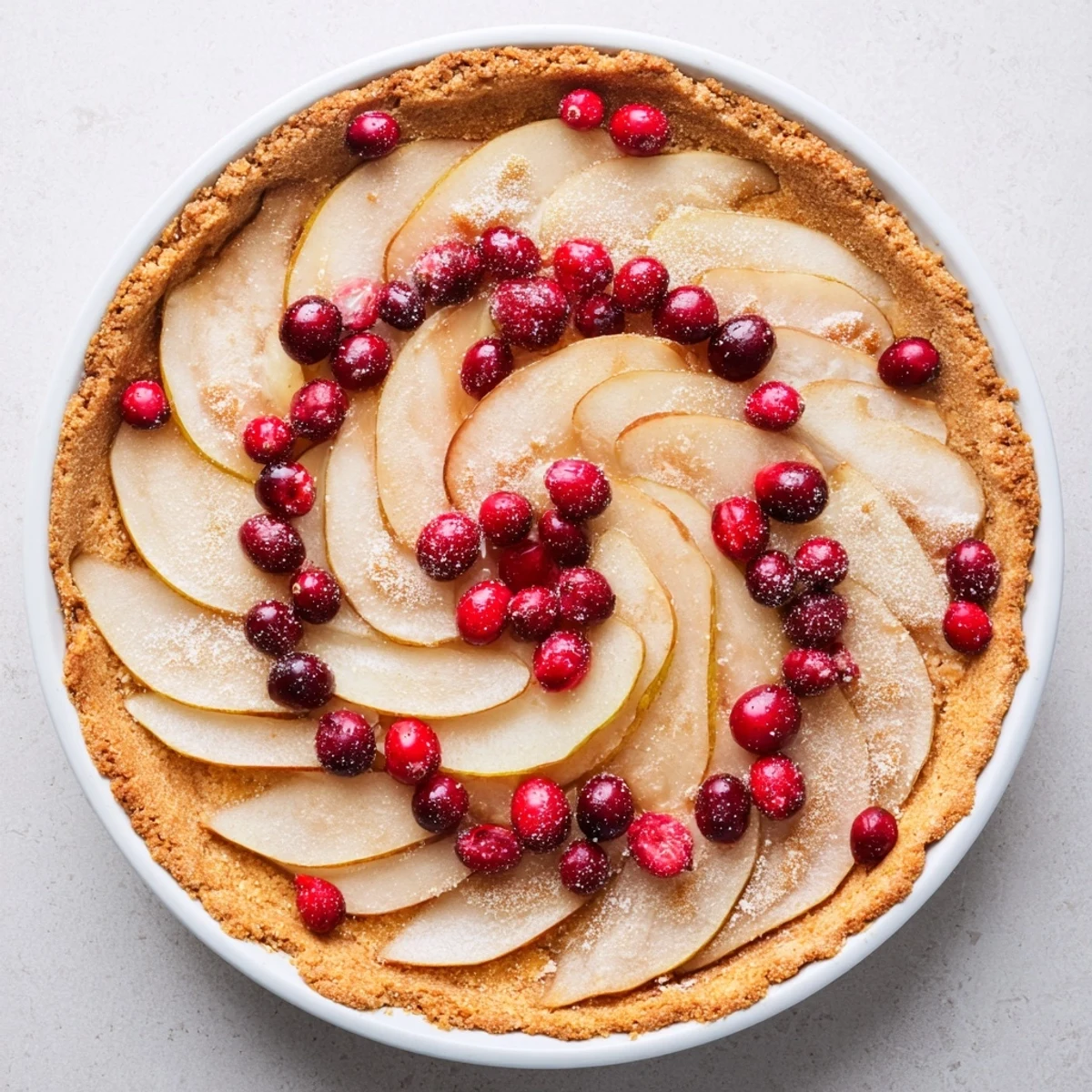 Homemade cranberry pear tart fresh from the oven with bubbling spiced fruit filling and golden edges