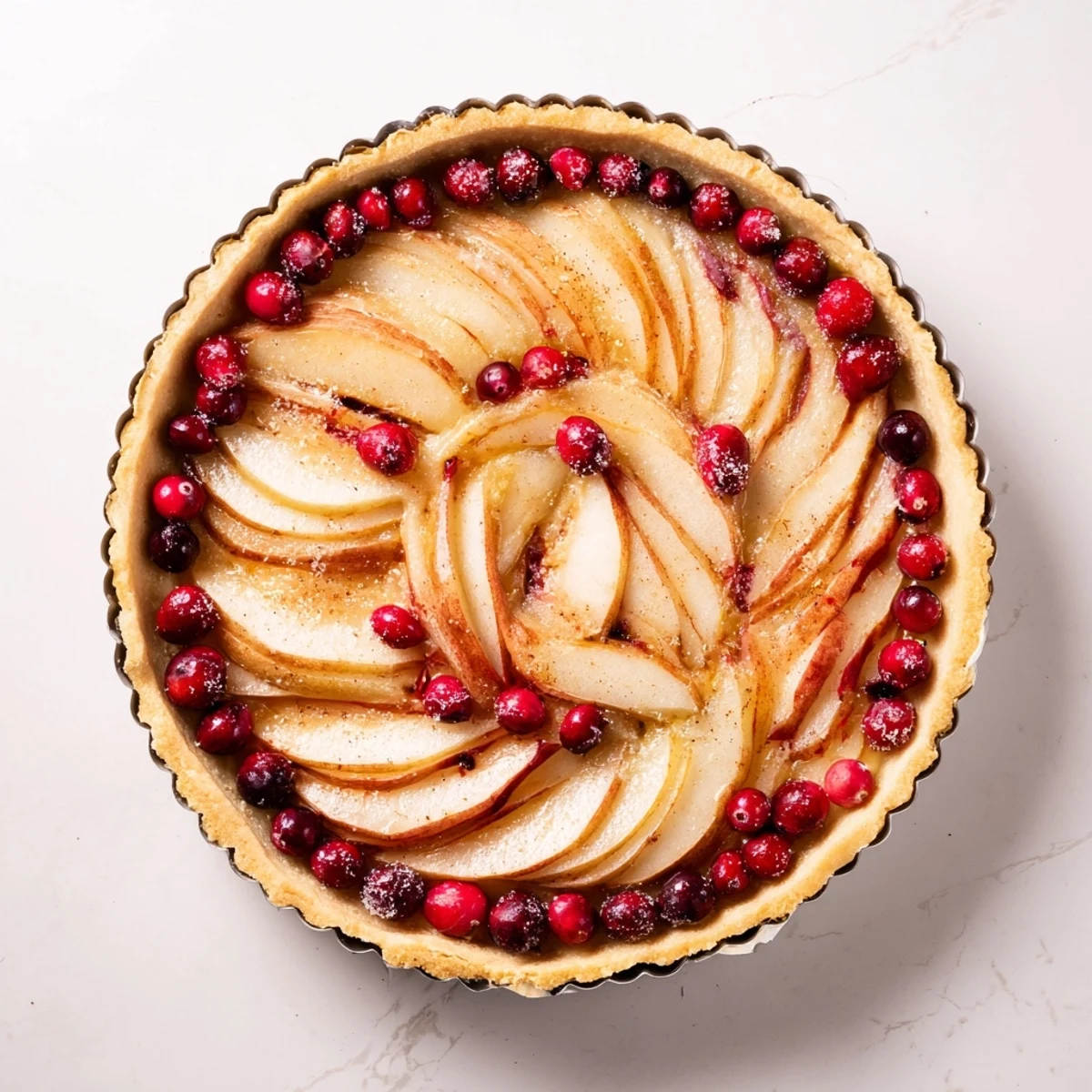 Rustic autumn dessert showcasing juicy pears and bright red cranberries in a flaky pastry crust