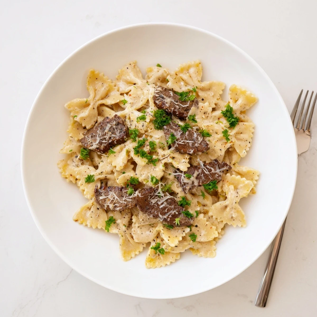 Cajun cream cheese Alfredo bowties with spiced beef in a rich, creamy white sauce