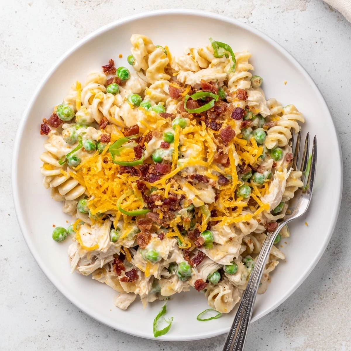 Slow cooker crack chicken casserole with tender pasta, ranch seasoning, and gooey cheese layers