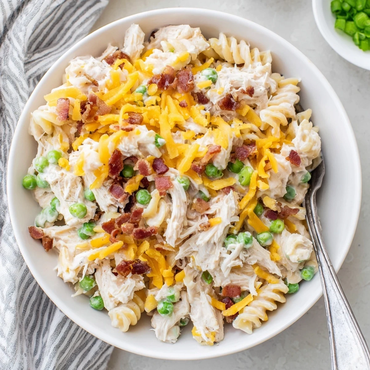 Steaming bowl of crack chicken casserole loaded with savory bacon, cheese, and rotini pasta