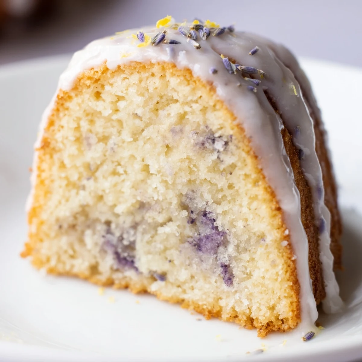 Moist lavender cake drizzled with sweet citrus glaze and garnished with fresh lavender sprigs