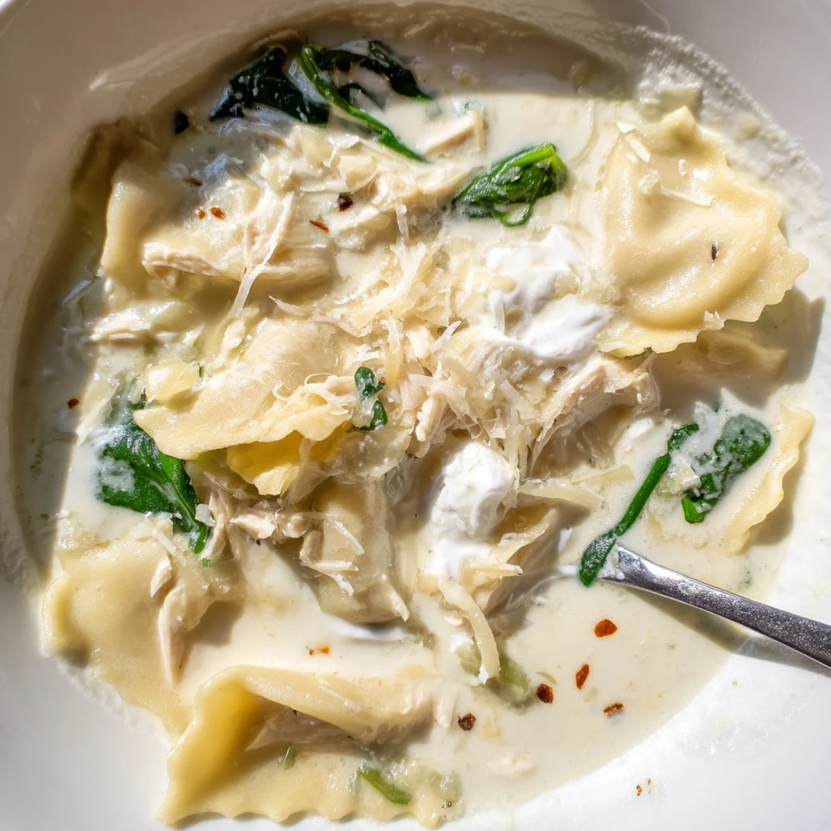 Creamy white lasagna soup in a rustic bowl topped with melted mozzarella and fresh herbs
