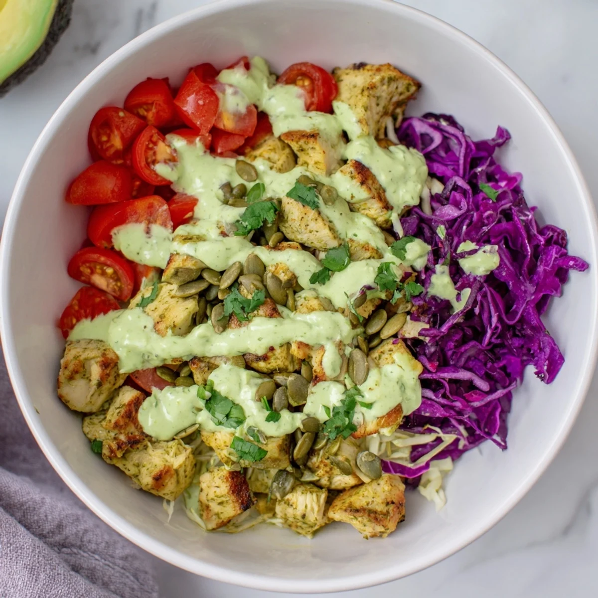 Colorful keto bowls loaded with fresh veggies, seasoned chicken, and creamy avocado dressing
