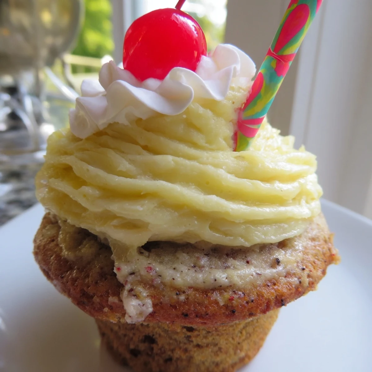 Moist banana milkshake cupcakes with golden cake crumb served on rustic white ceramic dessert plate