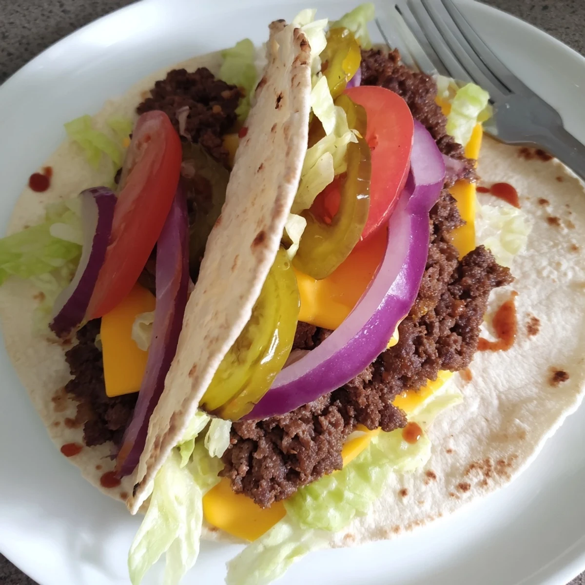 Smash Burger Tacos Recipe with crispy charred edges, melted cheddar, fresh tomato