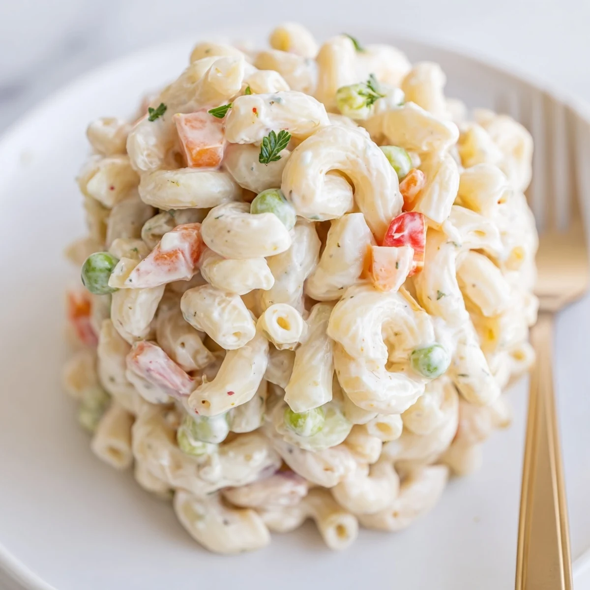 Chilled Macaroni Salad studded with peas, red onion, carrots, refreshing summer side