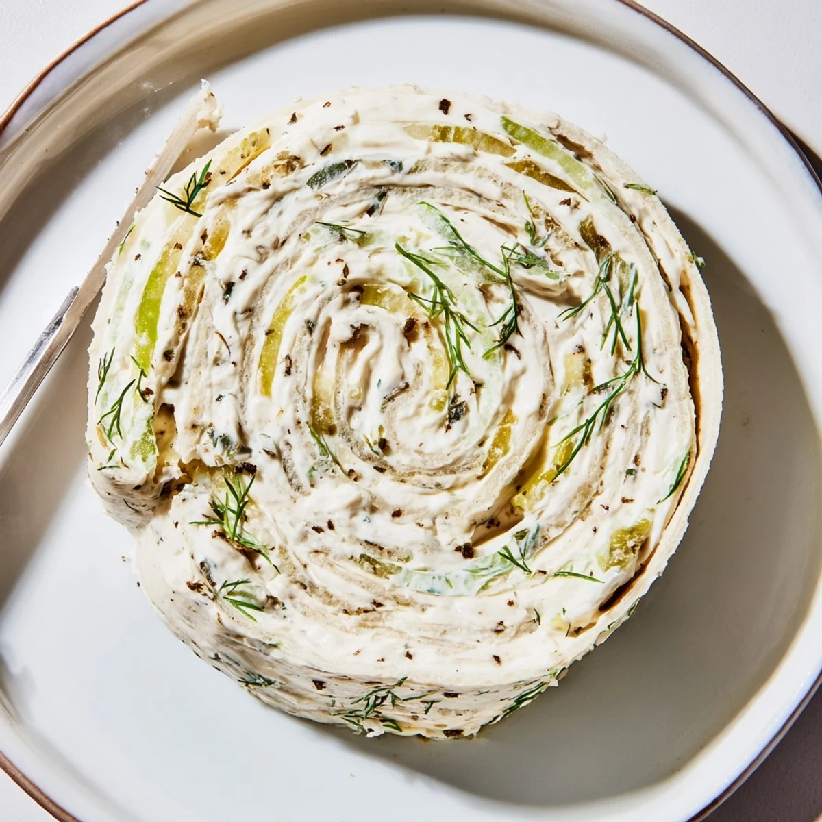 Pickle Dip Pinwheels on platter, creamy tangy filling with dill aroma