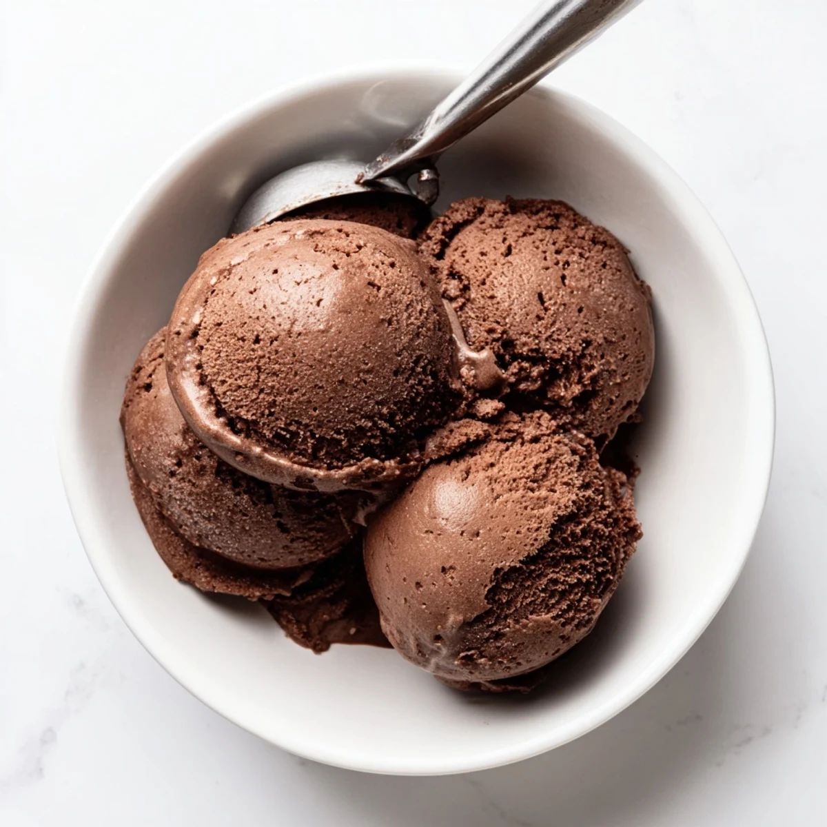 Rich chocolate sourdough ice cream swirl topped with flaky sea salt and fresh mint sprigs