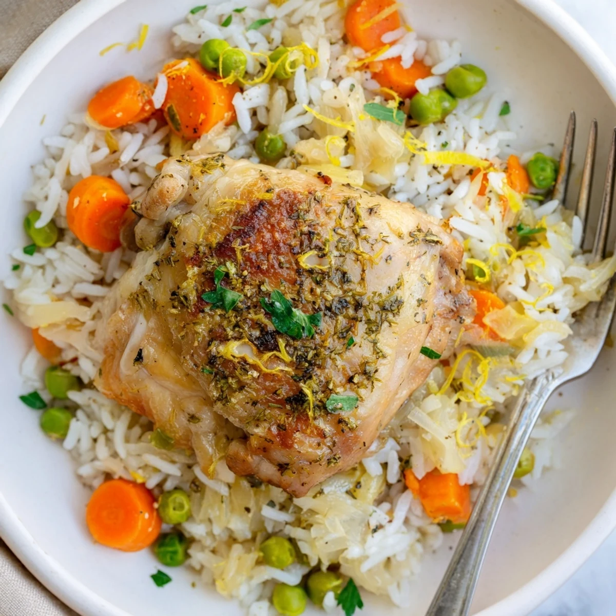 Steaming lemon-scented bowl of tender Slow Cooker Lemon Herb Chicken And Rice