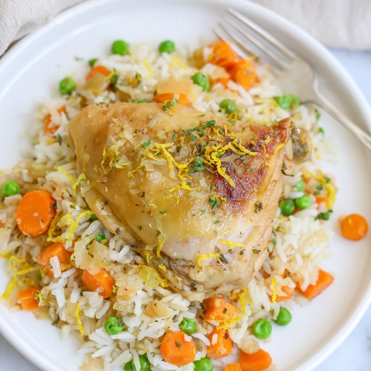 Hearty family dinner: tender thighs over fluffy Slow Cooker Lemon Herb Chicken And Rice