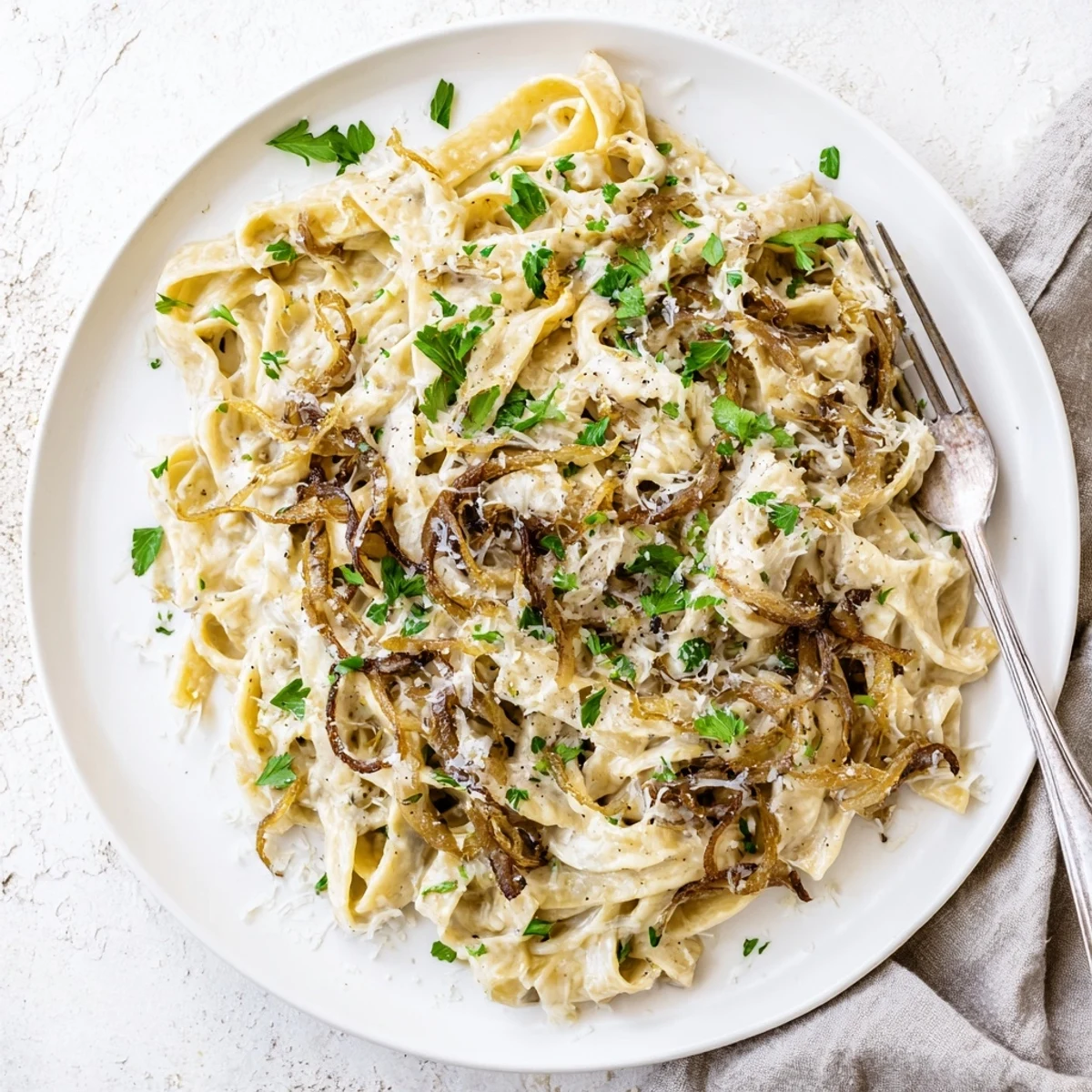 Fettuccine noodles tossed with rich caramelized onions and luxurious velvety cream