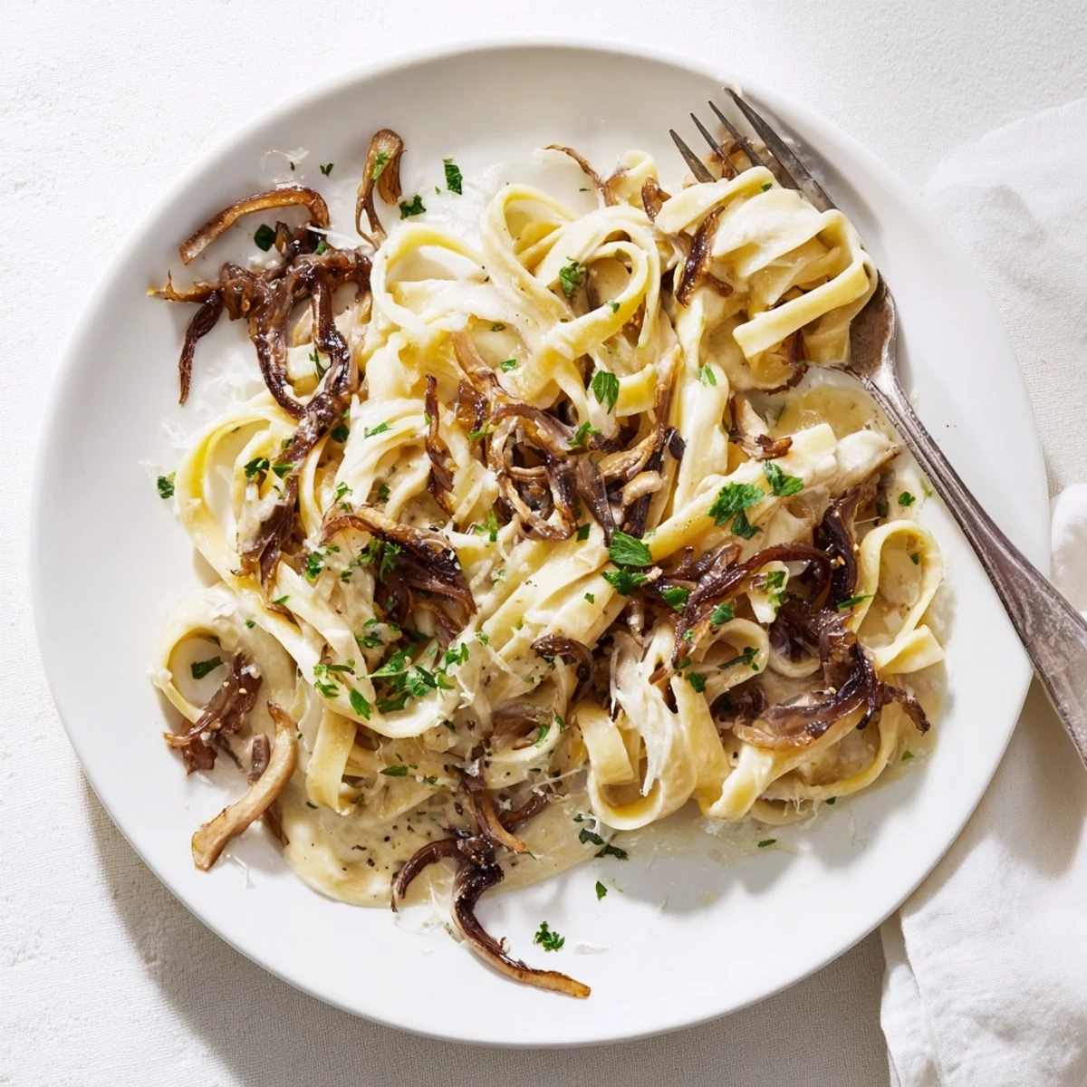 Golden brown caramelized onion cream pasta coated in silky parmesan sauce