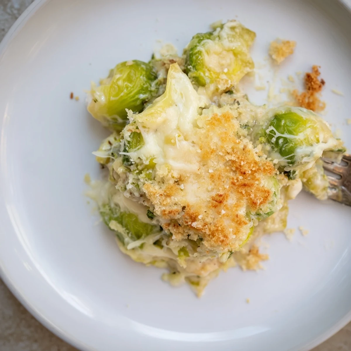 Creamy Parmesan Brussels Sprouts Casserole bubbling golden, silky sauce and crisp panko topping
