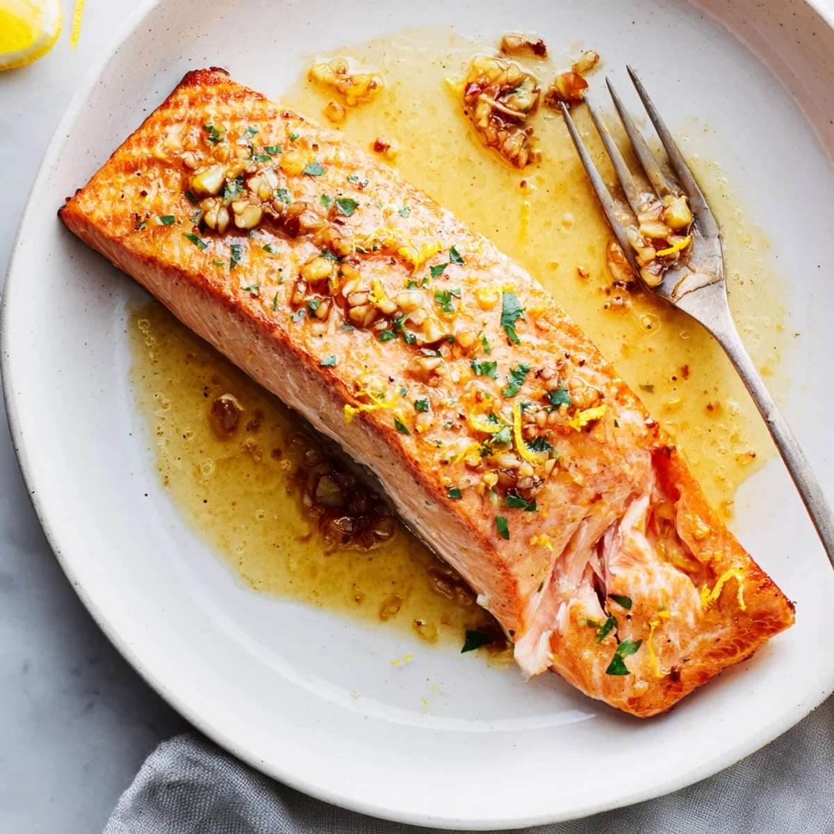 Crispy-skinned garlic butter salmon drizzled with melted butter and fresh parsley