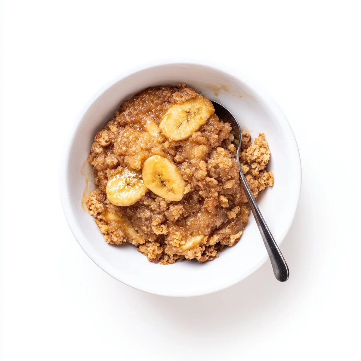 Rustic baking dish of Southern banana cobbler recipe featuring caramelized bananas and golden biscuit topping.