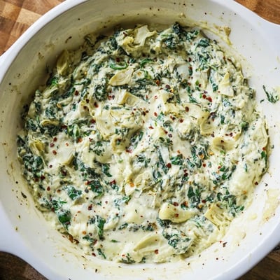 Golden-brown Spinach Artichoke Dip Ultimate Recipe in a baking dish, ready for parties and game day.