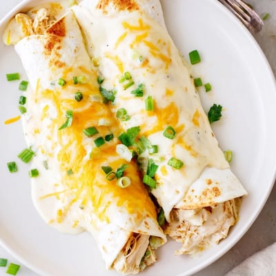 Oven-baked and steaming, Creamy White Chicken Enchiladas with melted Monterey Jack