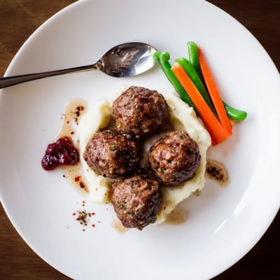 Warm Homemade Ikea Meatballs browned in skillet, served with tangy lingonberry jam